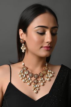 Beautiful High-Quality Imitation Kundan Beads Back Meena Choker Set, Indian Wedding Bridal Necklace, Pakistani Jewelry, Kundan Choker Set The majestically handcrafted Kundan necklace set is the best to match Indian tradition and intricate work handcrafted by the artisans of India. The Kundan set is a masterpiece inspired by Sabyasachi jewelry to give you a royal look. The bold and bright design of the necklace is perfect for all the beautiful women * Necklace Length: choker length  (comes with adjustable dori) * Earrings Length: 2 inches approx * Material: Brass and stone * Package: Necklace And Earring  STYLE TIP: This piece of elegant jewelry goes well with all your modern as well as traditional outfits. Best match for your wedding outfits ABOUT US: Jaipri makes each piece of its product Kundan Necklaces With Latkans For Party, Party Kundan Necklaces With Latkans, Elegant Jewelry With Motifs For Party, Elegant Necklaces With Motifs For Celebration, Elegant Celebration Necklaces With Motifs, Elegant Party Jewelry With Motifs, White Necklace With Latkans For Party, Party Meenakari Temple Jewelry Necklace, White Necklaces With Latkans For Parties