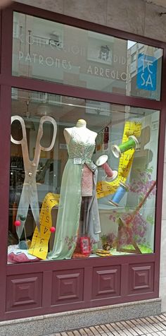 there is a display window with scissors and other items in the store's windows