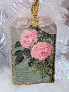 a christmas ornament with pink roses on it