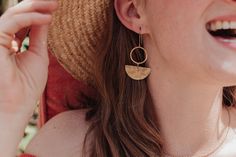 This collection of golden, artisan earrings is made from solid brass in beautiful Cornwall. The brass is hand beaten on a weathered, antique anvil, giving a unique and shimmering texture.  This range is inspired by the textures of ancient jewellery, paired with graphic, contemporary shapes. The look is bold and warm, reflecting the Summer sun or bringing a golden glow to grey days. My beaten brass is solid and raw, and can be left to patina naturally or kept to a glittering shine using the free jewellery polishing cloth provided. My jewellery is plastic free, as are my postage and packaging materials.  The French hook style ear wires are gold plated brass, and fully hypoallergenic. Length 62mm x 31mm Individual earring length 3.02gms By shopping with Nic Danning Jewellery you are supportin Contemporary Shapes, Ancient Jewellery, Women's Circle, Woman Card, Artisan Earrings, Golden Glow, Ancient Jewelry, Brass Gold, Single Earring