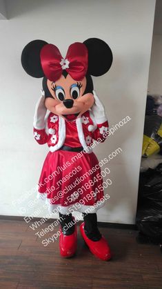 the minnie mouse mascot is dressed in red and white