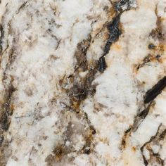 a marble counter top with brown and white colors