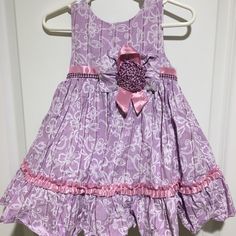 Size 18 Months Beautiful Dress With Floral Print And Ruffles. Washed But Never Worn. Includes Matching Diaper Cover. 18 Inches From The Top Of The Shoulder To The Hem. Fully Lined And With Layers To Make The Skirt Poofy. Cute Purple Sleeveless Dress, Purple Cotton Ruffle Dress, Purple Cotton Dress With Ruffles, Cute Purple Dress For Dress-up, Cute Purple Cotton Dress, Purple Cotton Dress For Playtime, Dress With Floral Print, Month Colors, Diaper Cover