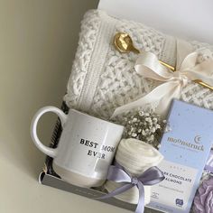 a white blanket and coffee mug in a box