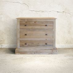 a wooden dresser sitting in front of a white wall