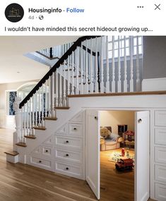 an open door leading to a staircase in a room with white cabinets and drawers on the floor