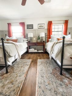 two beds in a room with wooden floors