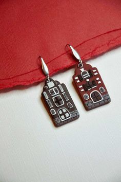 Dancing houses, inspired by the beautiful architecture along Damrak canal, in Amsterdam.  DETAILS -Polymer clay in different shades, main colors Black and Burgundy.  -All backings are surgical stainless steel which makes each earring hypoallergenic. Due to the handmade nature of each item, expect slight variations. PROCESSING TIME Processing time before shipping your order will be around  7-10 business days , since this item is individually handmade-to-order. If you need it by a specific date, p Landscape Earrings, Dancing House, Small Jewelry Box, Earrings Polymer Clay, Modern Earrings, Travel Jewelry, Small Jewelry, Earrings Statement, Beautiful Architecture