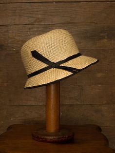 "An authentic antique woven cloche from the late 1920s or 30s era. Originally acquired by a European hat shop that closed in the 1930s. Made from a light colored woven straw with a simple yet elegant black wax coated ribbon and buckle. Only minor signs of age from storage, never been previously used. Centimeter measurements written on the inside of the crown by the hat maker. material : straw, silk? ribbon color : black, light beige condition : little to no wear, has never been used size : pleas Adjustable Cloche Flapper Hat, Adjustable Cloche Hat In Flapper Style, Adjustable Wide Brim Flapper Hat, Fitted Flapper Cloche Hat With Brim, Vintage Black Straw Hat With Short Brim, Flapper Style Short Brim Cloche Hat For Kentucky Derby, Vintage Fitted Wide Brim Cloche Hat, Vintage Wide Brim Fitted Cloche Hat, Fitted Wide Brim Vintage Cloche Hat