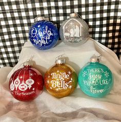 four christmas ornaments are sitting on a blanket