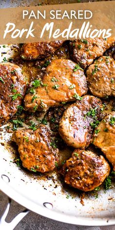 pan seared pork medallions with parsley on top in a white skillet