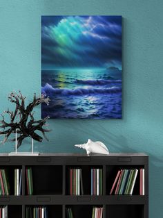 a painting on the wall above a bookshelf with an ocean scene in it