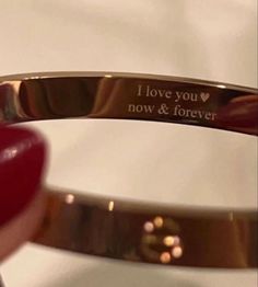 a couple of gold bracelets that say i love you now and forever