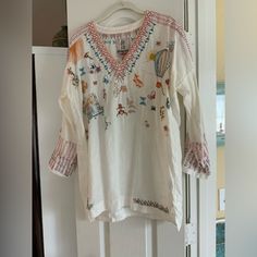 Beautiful Embroidered Linen Top By Johnny Was. Size Is Xs However Their Linens Run Large. Bust Lying Flat Pit To Pit Is 23-1/2. Fits More Like A Small To Medium. New With Tags Casual V-neck Embroidered Top With Multicolor Embroidery, Spring Geometric Embroidery Tunic Top, Casual Embroidered Spring Tunic Top, Spring White V-neck Embroidered Top, White V-neck Embroidered Top For Spring, Relaxed Fit V-neck Embroidered Top With Floral Embroidery, Relaxed Fit V-neck Top With Floral Embroidery, Casual Multicolor Embroidered V-neck Top, Casual V-neck Embroidered Top With Floral Print