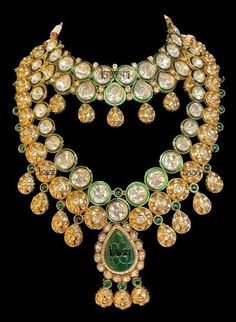 "Asmi - Gold Indian Jewelry Set w/ Green Meenakari, Emerald & Kundan for Brides Indian gold-plated jewelry w/ Kundan Gems and huge Emerald rock at the centre. Fit for any modern woman who appreciates the beauty of fine craftsmanship and design all in one stunning set! Clear Kundan stone all around adorns this bridal set. This jewelry is elaborated with embellished green meenakari detailed outlining the Kundan gems. This modern bridal jewelry is further accented with green precious emerald to add Luxury Gold Necklaces With Meenakari, Luxury Gold Kundan Necklace With Meenakari, Luxury Yellow Gold Kundan Necklace For Festive Occasions, Luxury Gold Meenakari Jewelry, Luxury Gold Jewelry With Meenakari, Luxury Gold Kundan Necklace With Intricate Design, Opulent Hallmarked Wedding Jewelry, Ornate Gold Kundan Necklace With 17 Jewels, Luxury Meenakari Necklaces For Celebration