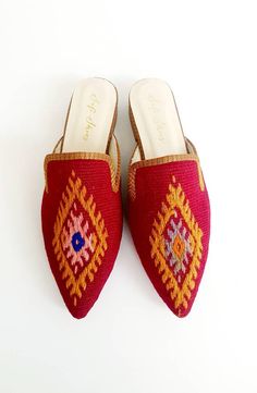 Crafted by artisans skilled in the great Turkish shoemaking tradition, our handmade ikat mules are crafted of genuine leather soles and only the finest natural cotton kilim, raw silk and silk velvet textiles available. As each of our stunning ikat mules are made by hand, no two pairs are exactly alike. Thus, each pair of these luxury mules is entirely unique -- just like you! Our luxury ikat mules are available in a wide array of colors and patterns, in both rounded and pointed toe-styles. We of Handmade Bohemian Closed Toe Mules, Bohemian Handmade Slip-on Mules, Handmade Bohemian Slip-on Mules, Handmade Artisan Mules For Summer, Handmade Bohemian Mules For Spring, Artisan Handmade Slip-on Mules, Traditional Summer Mules With Pointed Toe, Traditional Pointed Toe Mules, Traditional Handmade Flat Mules