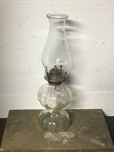 a glass vase sitting on top of a wooden box