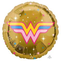 a gold foil balloon with the wonder woman symbol on it's face and stars