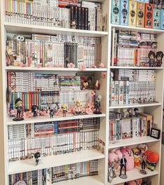 a book shelf filled with lots of books and anime figurines on top of it