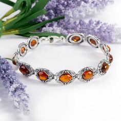 Sterling Silver and Baltic Amber Vintage Style Link Bracelet, Amber Bracelet, Statement Bracelet, Boho Bracelet, Vintage Gift Go back in time with our Silver and Amber Vintage Style Link Bracelet. Beautifully crafted in 925 Sterling Silver, this stunning bracelet is adorned with 12 single oval shaped genuine Baltic Amber gemstones. Each stone is set and surrounded by a decorative vintage style mount and they are individually hinged together to create a classic and sophisticated accessory. Comple Palm Necklace, Silver Bird Necklace, Go Back In Time, Amber Gemstone, Amber Bracelet, Pierced Jewelry, Boho Bracelet, Bracelet Boho, Mothersday Gifts