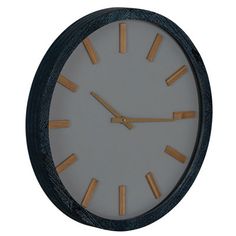 a clock that is on the side of a wall with wooden sticks sticking out of it