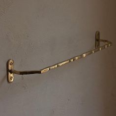 a metal hook on the wall holding something