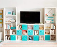 an entertainment center with blue and white storage boxes on each side, including a flat screen tv