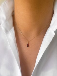 "A deep red garnet tear drop hung from a delicate gold chain. A beautiful gift to show someone you care, or a little bit of self love. Garnet is the birthstone of the January born. The necklace pictured is 16\" though custom lengths are available on request. Available in 9ct gold, gold filled as pictured, rose gold filled and sterling silver. Comes beautifully gift wrapped as pictured. Garnet is a spiritual stone of higher thinking and self-empowerment, it is also a stone of strength and safety. It is a stone of prosperity and abundance, encouraging gratitude and service to others.  Gold filled is made by heat and pressure bonding a layer of karat gold to a metal core. Unlike gold plated, gold filled has an actual layer of karat gold, not just a microscopic film and with the proper care wi Red Gemstone Drop Necklace For Gift, Dainty Rose Gold Teardrop Pendant Charm Necklace, Teardrop Birthstone Drop Necklace Gift, Minimalist 14k Gold Drop Necklace As Gift, Minimalist 14k Gold Drop Necklace Gift, Minimalist 14k Gold Drop Necklace For Gift, Dainty Long Drop Necklace As Gift, Rose Gold Long Drop Necklace Gift, Red Minimalist Birthstone Necklace