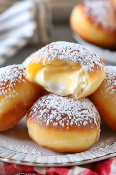 powdered sugar covered donuts on a plate