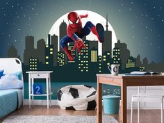 a bedroom with a spiderman mural on the wall and a soccer ball in the foreground