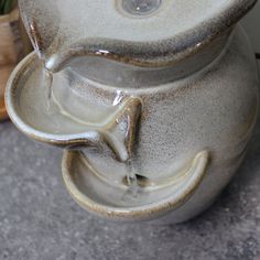 a close up of a vase with water coming out of the top and inside it