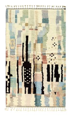 a multicolored rug with fringes on the bottom and an abstract design on the top