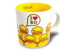 a yellow and white coffee mug with ducks on the inside, i love bd