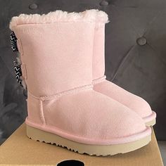 Ugg Bailey Bow Toddler Boots Pink Color Brand New & Comes With Original Box Multiple Sizes Available 7 Toddler And 8 Toddler 100% Autthentic, Bought From Ugg Store This Take On The Popular Bailey Bow Features An Artistic Squiggle-Striped Pattern For Playful Pop Of Color And Texture. It's Built For Kids On The Move With A Super-Lightweight Outsole For Traction And Durability. Responsibly Sourced Materials Include Recycled Polyester Binding And Uggpure Upcycled Wool Insole. Treadlite By Ugg Propri Black Glitter Boots, Toddler Uggs, Holiday Boots, Grey Uggs, Ugg Bailey Boots, Toddler Ugg Boots, Ugg Bailey Bow, Pink Core, Ugg Store