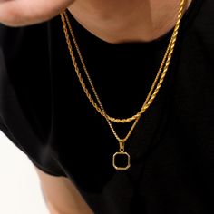 The black onyx pendant on a gold round box chain is a striking and sophisticated piece of jewelry. The pendant showcases a sleek and polished black imitation onyx stone, renowned for its deep black color and smooth surface. The stone is expertly set in a luxurious gold bezel, accentuating its elegance and creating a captivating contrast. The pendant gracefully hangs from a gold round box chain, featuring interconnected square links that lend a modern and stylish appearance. The chain perfectly c Black Pendant Chain Necklace, Tarnish Resistant, Black Tarnish Resistant Pendant Chain Necklace, Black Tarnish Resistant Pendant Necklace, Black Tarnish-resistant Pendant Chain Necklace, Gold Onyx Pendant Jewelry, Minimalist Black Snake Chain Jewelry, Black Rope Chain Necklace As Gift, Black Box Chain Necklace For Formal Occasions, Black Box Chain Necklace For Formal Events