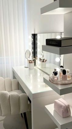 a white counter top sitting under a window next to a chair and table with makeup on it