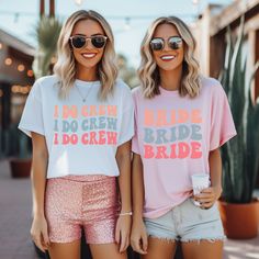 two women standing next to each other wearing t - shirts that say i do crew and i do crew