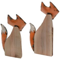 two wooden foxes are standing next to each other