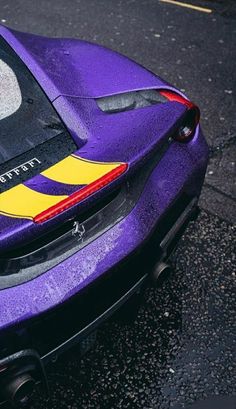 a purple sports car is parked on the street