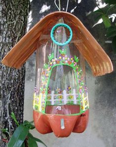 a bird feeder hanging from the side of a tree