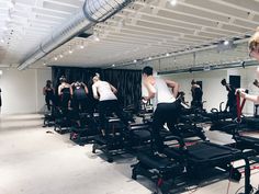 a group of people in a gym with treadmills