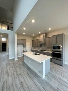 an empty kitchen and living room in a new home