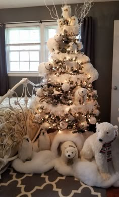 a white christmas tree decorated with teddy bears