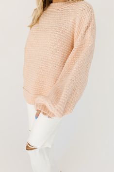 cozy + cool, this oversized peach sweater is a spring wardrobe essential. it has the ideal slouchy silhouette + is made in the most stunning pastel peach color. the perfect oversized knit to throw on + slay any casual outing or fam gathering. peach // high neckline, drop shoulder, balloon sleeves paired with our mimi wide leg denim + parker double strap heels // free people model is 5'7" + wearing a medium measurements are approximate + taken while laying flat small : bust 52” length 24” medium Spring Cozy Cropped Sweater With Soft Texture, Cozy Cropped Sweater For Spring With Soft Texture, Soft Knit Feminine Sweater, Feminine Soft Knit Sweater, Feminine Textured Knit Sweater, Chunky Knit Sweater For Loungewear In Spring, Soft Texture Cropped Sweater For Spring, Oversized Cream Sweater With Soft Texture, Oversized Soft Cream Sweater