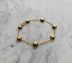 Morning Star. This bracelet is composed of 14K gold vermeil delicate chain and gold plated hematite tiny star charms, that shine and glow. So pretty and easy to wear! It also makes a very cute gift! Not sure which length to buy? We can add a 1 inch extender chain. Just write a note at checkout! ❈ We send all our items with registered mail. ❉ Due to the organic nature of stones, there might be a slight variation in colour, size and shape. ✺ All items come packaged in a quality velvet pouch ready Gold Jewelry With Star Print For Gift, Gold Star Chain Bracelet As Gift, Gold Charm Bracelet With Star Charm As A Gift, Gold Celestial Charm Bracelet As A Gift, Gold Bracelet With Star Charm As Gift, Gold Star Bracelets For Everyday, Handmade Gold Star Bracelets, Gold Bracelets With Star Charm For Gift, Gold Bracelet With Star Charm For Gift