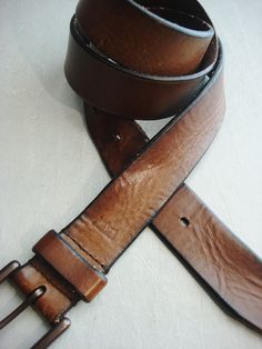 Men levi's distressed brown leather belt sz 38 strap length 46 long width: 1 1/4 buckle: 2x2 fits a 38-43 inch waist thick distressed leather, heavy metal buckle good vintage condition slight bow in the center clean Rustic Leather Belt Buckle With Removable Belt, Vintage Brown Leather Belt With Removable Feature, Vintage Brown Leather Belts And Suspenders With Antique Buckle, Vintage Brown Leather Belts With Antique Buckle, Vintage Brown Leather Belt With Antique Buckle, Rustic Leather Belt With Antique Buckle, Rustic Distressed Brown Belt Buckle With Antique Design, Rugged Distressed Brown Belt With Antique Buckle, Rugged Brown Leather Belts And Suspenders