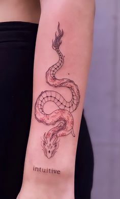 a woman's arm with a snake tattoo on the left side of her body