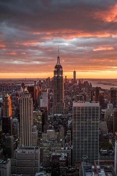 the sun is setting over new york city in this view from top of the rock