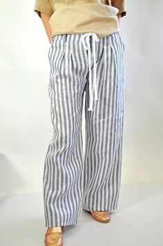 "Wide Legged Linen Trousers with Belt and Pockets, High Waisted Pants, Summer Palazzo Pants, Beach Pants for Women, Striped Pants for Ladies Natural Linen stiped pants. Summer Loose Drop crotch  Pants. Loose linen pants. Every day  comfortable pants.  Maxi trousers. Cool casual pants. Striped  100% lINEN pants.  Comfortable and Relaxed. Zipped pants. Model wearring size S Color : Striped blue/ white   Fabric: Linen 100% The style I used was originally designed and professionally constructed by me. Each item of my shop has a special package. Handmade in a pet-free and smoke- free environment. Size chart Gabyga: XS (US 2, UK 6) Bust: around 33.5\" / 85 cm Waist: around 26\" / 66 cm Hips: around 36\" / 91 cm Height: 5'3\" / 160 cm S (US 6, UK 10) Bust: fits Bust around 35.5\" / 90 cm Waist: f Striped Linen Beach Pants, Striped Straight Pants For Beach, Striped Trousers For The Beach, Striped Pants For The Beach, Striped Beach Trousers, Long Linen Pants, Package Handmade, Loose Linen Pants, Blue White Fabric