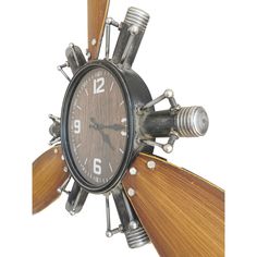 a clock made out of metal and wood with multiple propeller blades on the front side